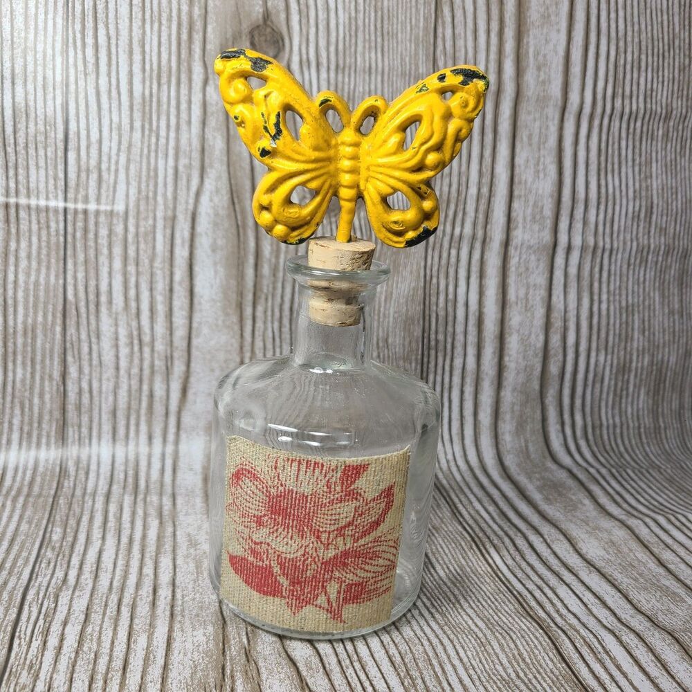 Rustic cast iron yellow butterfly cork stopper with decorative apothecary bottle